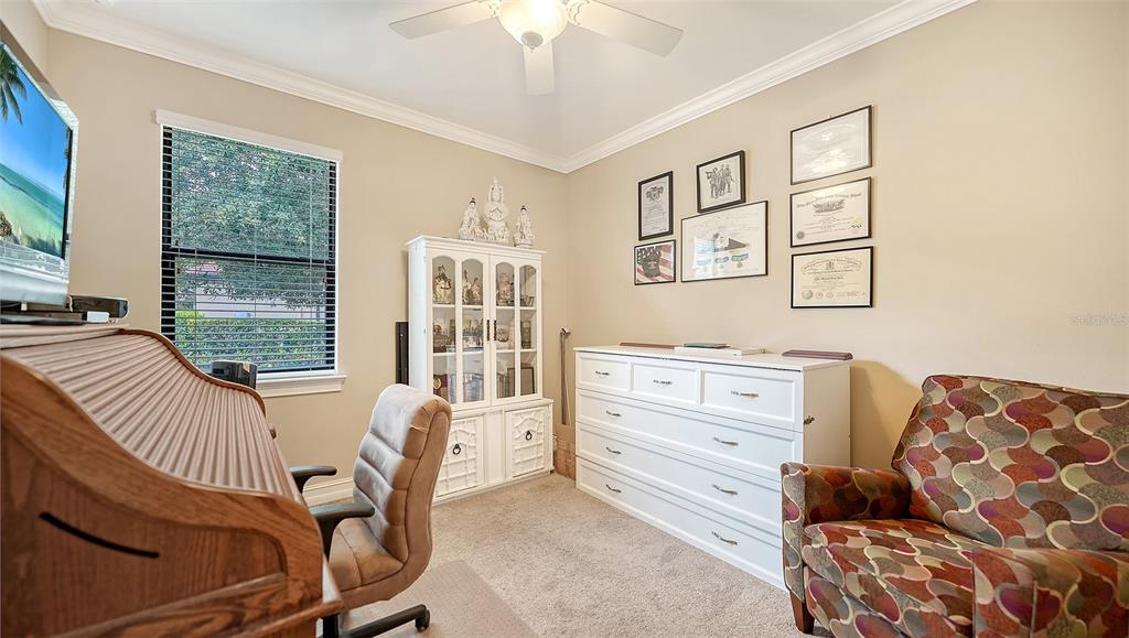 A home office features a roll-top desk, a white cabinet, a dresser, and patterned armchair — 1051 BRADBERRY DRIVE, NOKOMIS, FL