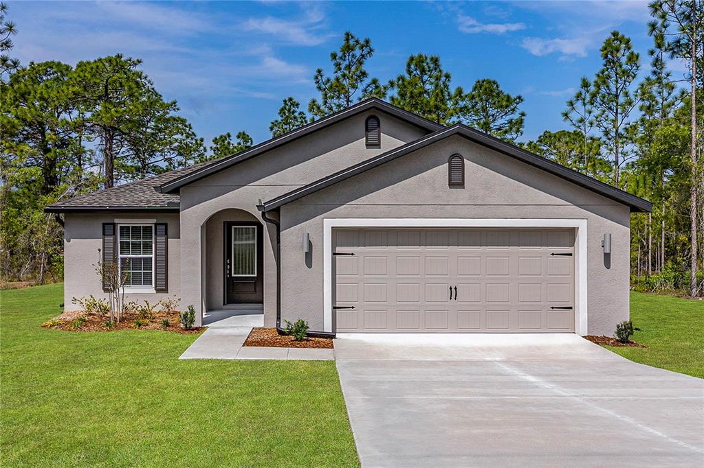 A single-story house with a gray stucco exterior, a two-car garage, and a front entrance — 7220 SWARTBURG ROAD, NORTH PORT, FL