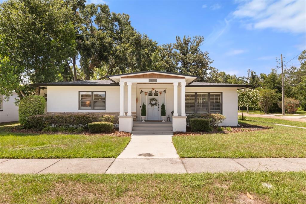A single-story white house with a front porch, columns, and a concrete walkway — 934 BOARDMAN STREET, ORLANDO, FL