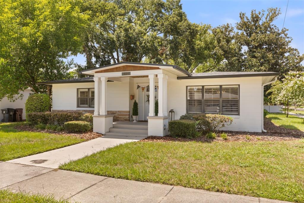 A single-story white house with a covered front porch and a concrete walkway — 934 BOARDMAN STREET, ORLANDO, FL