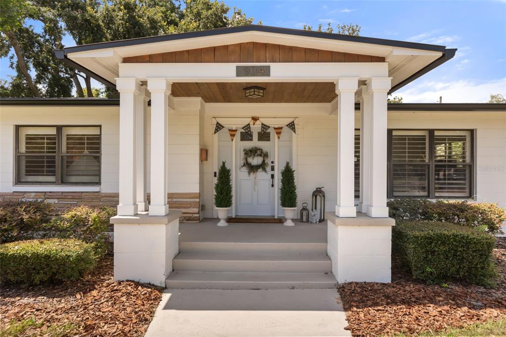 The front exterior of a single-story house features a covered porch with white columns — 934 BOARDMAN STREET, ORLANDO, FL