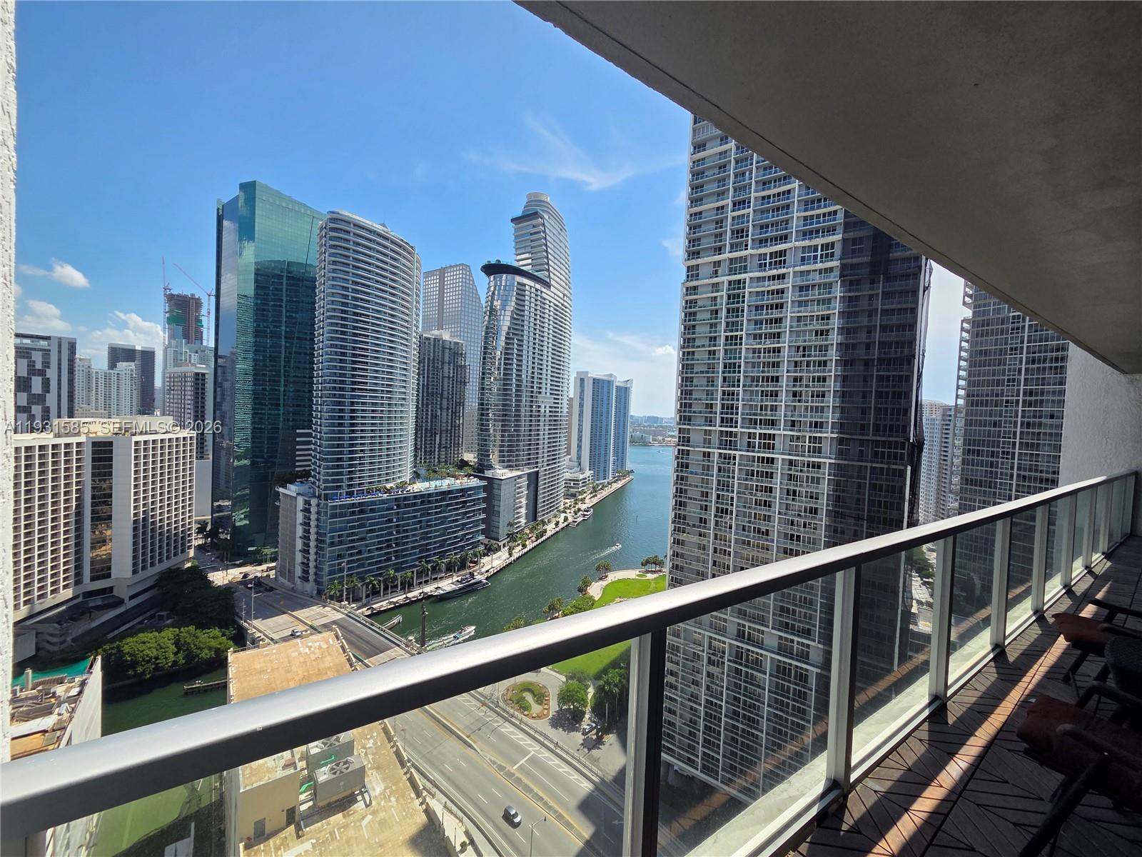A balcony overlooks a canal and high-rise buildings in a city skyline — 500 Brickell Ave # 3105, Miami FL 33131, MIAMI, FL