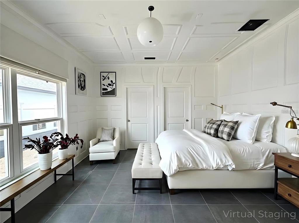 A bedroom features white paneled walls, a white bed, a bench, and gray tile flooring — 1405 W 14TH STREET, SANFORD, FL