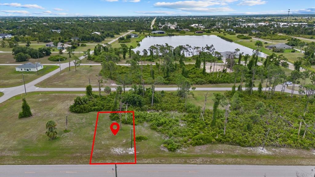 An aerial view shows a vacant rectangular lot outlined in red along a paved road — 55 MASTHEAD ROAD, PLACIDA, FL