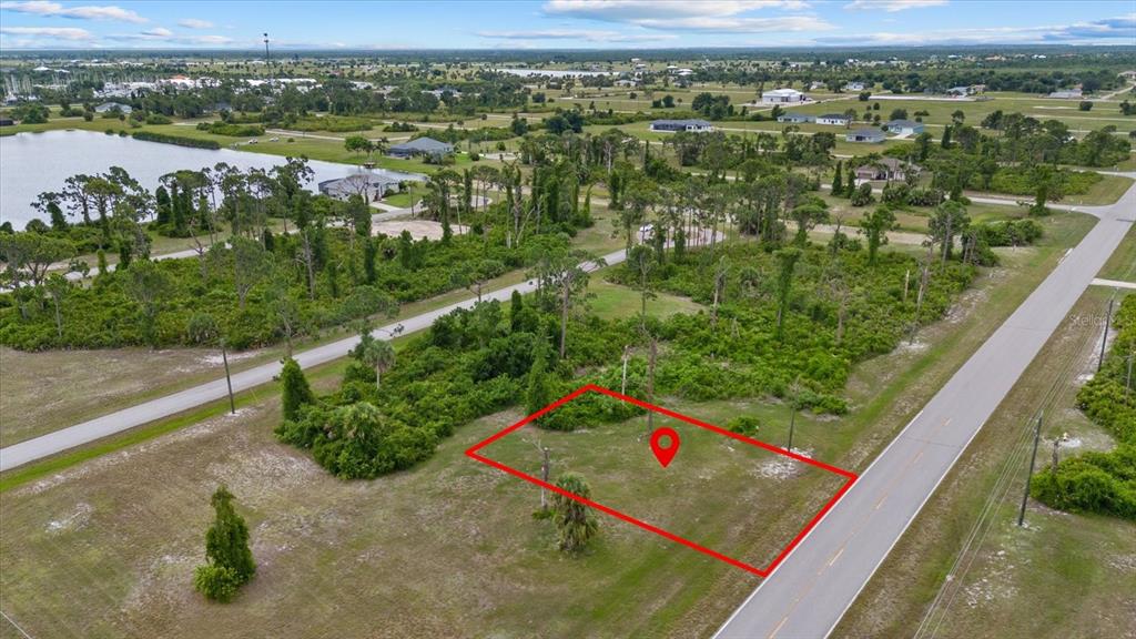 An aerial view shows a vacant, rectangular lot outlined in red next to a paved road — 55 MASTHEAD ROAD, PLACIDA, FL