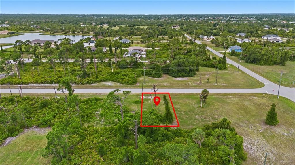 An aerial view shows a vacant, rectangular lot outlined in red along a paved road — 55 MASTHEAD ROAD, PLACIDA, FL