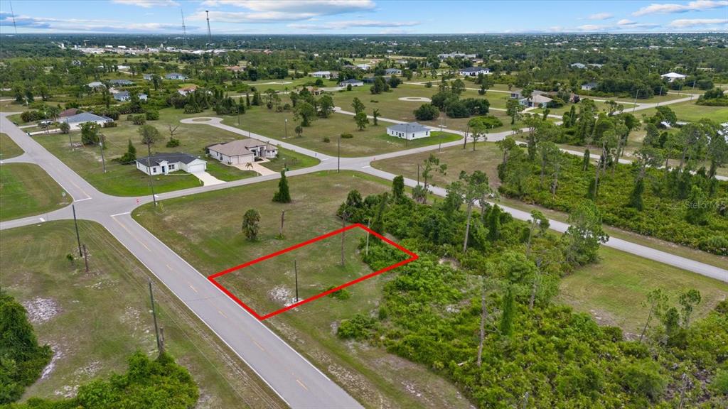 An aerial view shows a vacant rectangular lot outlined in red along a paved road — 55 MASTHEAD ROAD, PLACIDA, FL