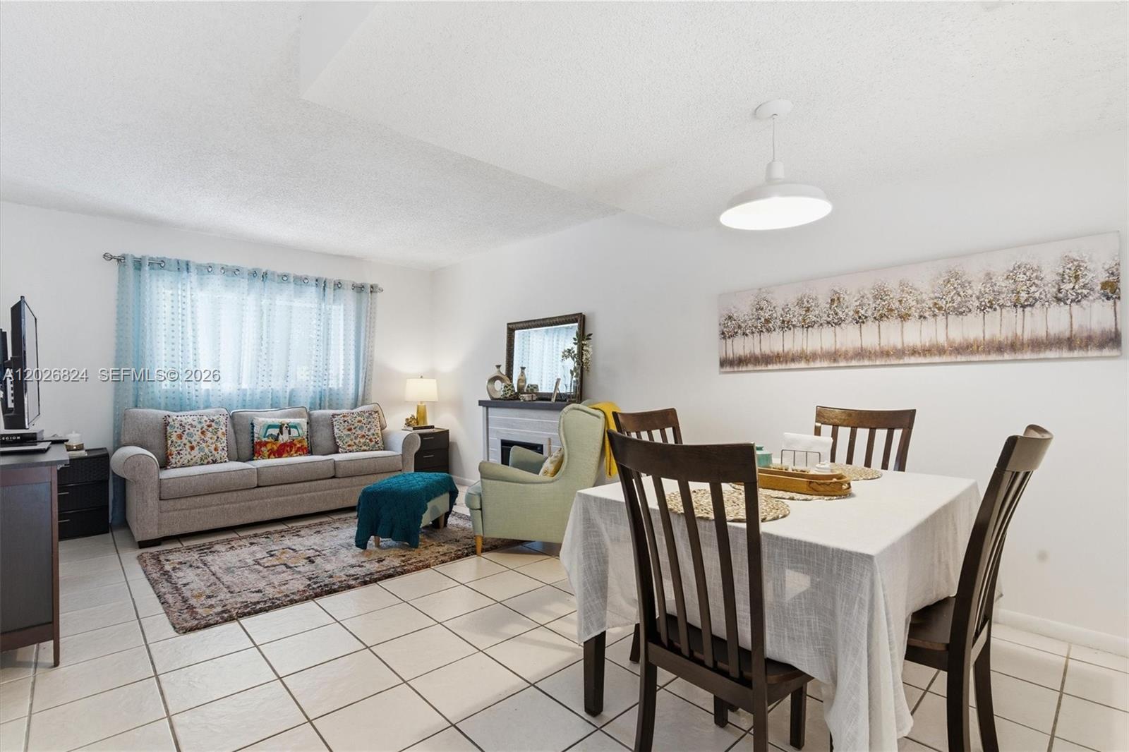 A living and dining area features white tile floors, a grey sofa, and a dining table — 8240 SW 149th Ct # 201, Miami FL 33193, MIAMI, FL