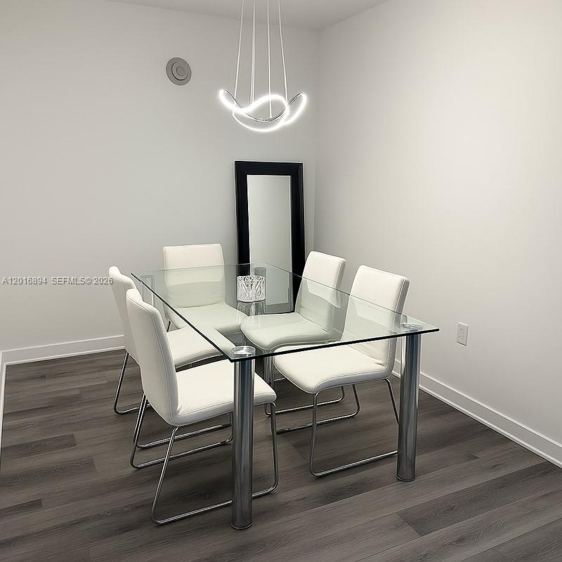 A dining area features a glass-topped table, white chairs, a modern light fixture, and wood-look flooring — 79 SW 12th St, Miami FL 33130, MIAMI, FL