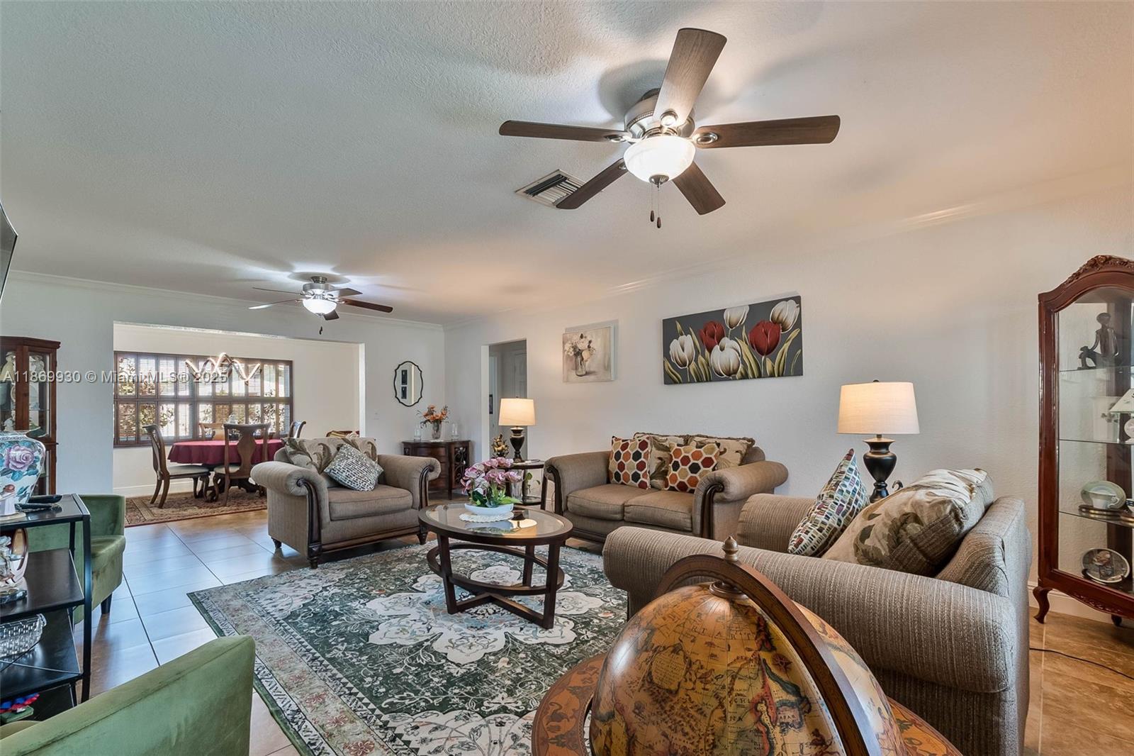 A living room features a patterned area rug, two sofas, a coffee table, and a globe — 9021 NW 13th St, Plantation FL 33322, PLANTATION, FL