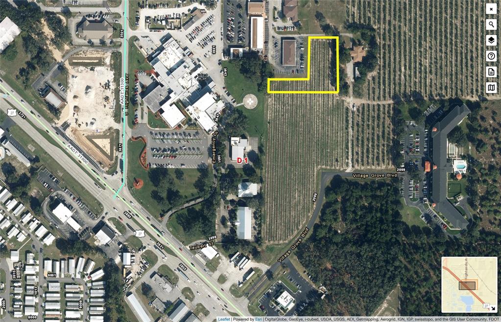This is an aerial map showing a highlighted L-shaped parcel of land near a commercial area — 310 MEDICAL CENTER AVENUE, SEBRING, FL