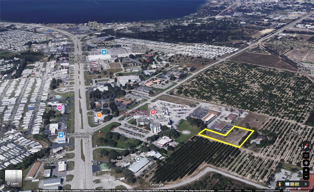 This is an aerial map view showing a highlighted vacant lot near a hospital and highway — 310 MEDICAL CENTER AVENUE, SEBRING, FL