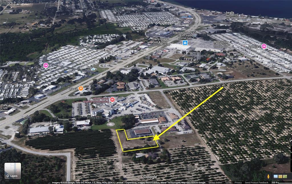 An aerial map view highlights a vacant L-shaped lot adjacent to a hospital and orchard — 310 MEDICAL CENTER AVENUE, SEBRING, FL
