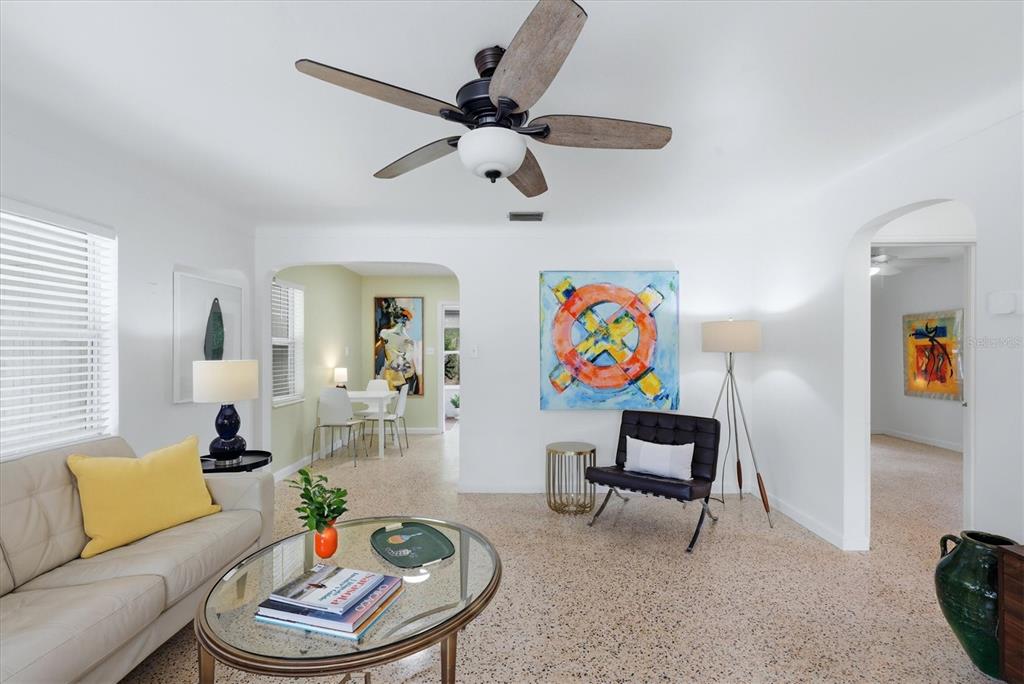 A living room with a ceiling fan, terrazzo floors, and a black leather accent chair — 1020 23RD STREET, SARASOTA, FL