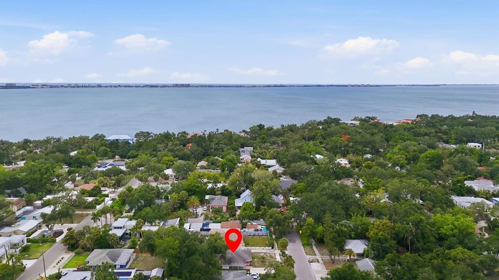 An aerial view shows a residential house with a red pin in a coastal neighborhood — 1020 23RD STREET, SARASOTA, FL