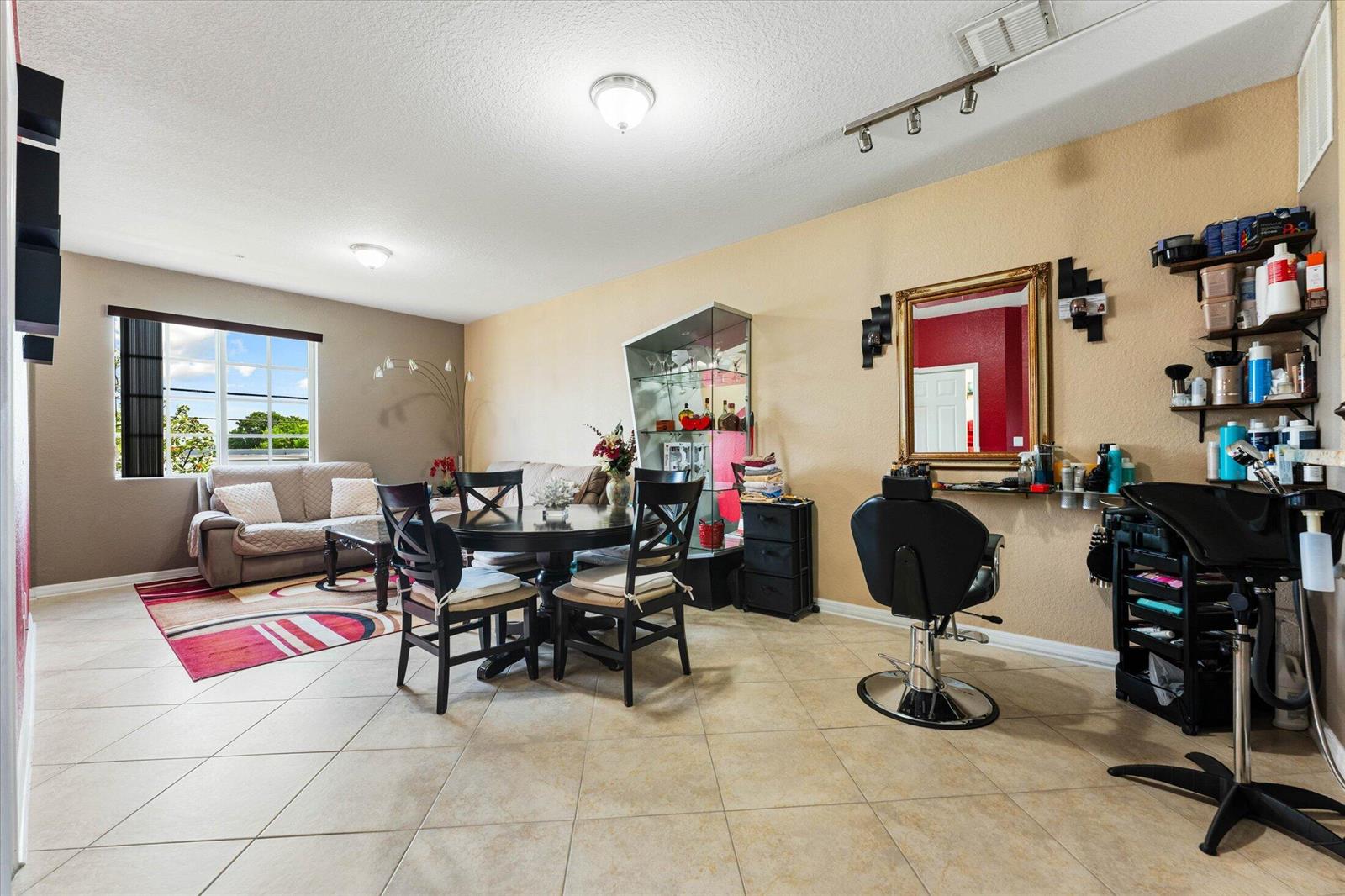 A multi-purpose room featuring a living area, dining set, and a home hair salon station — 131 NW 2nd Avenue # 3, FL 33009, FL