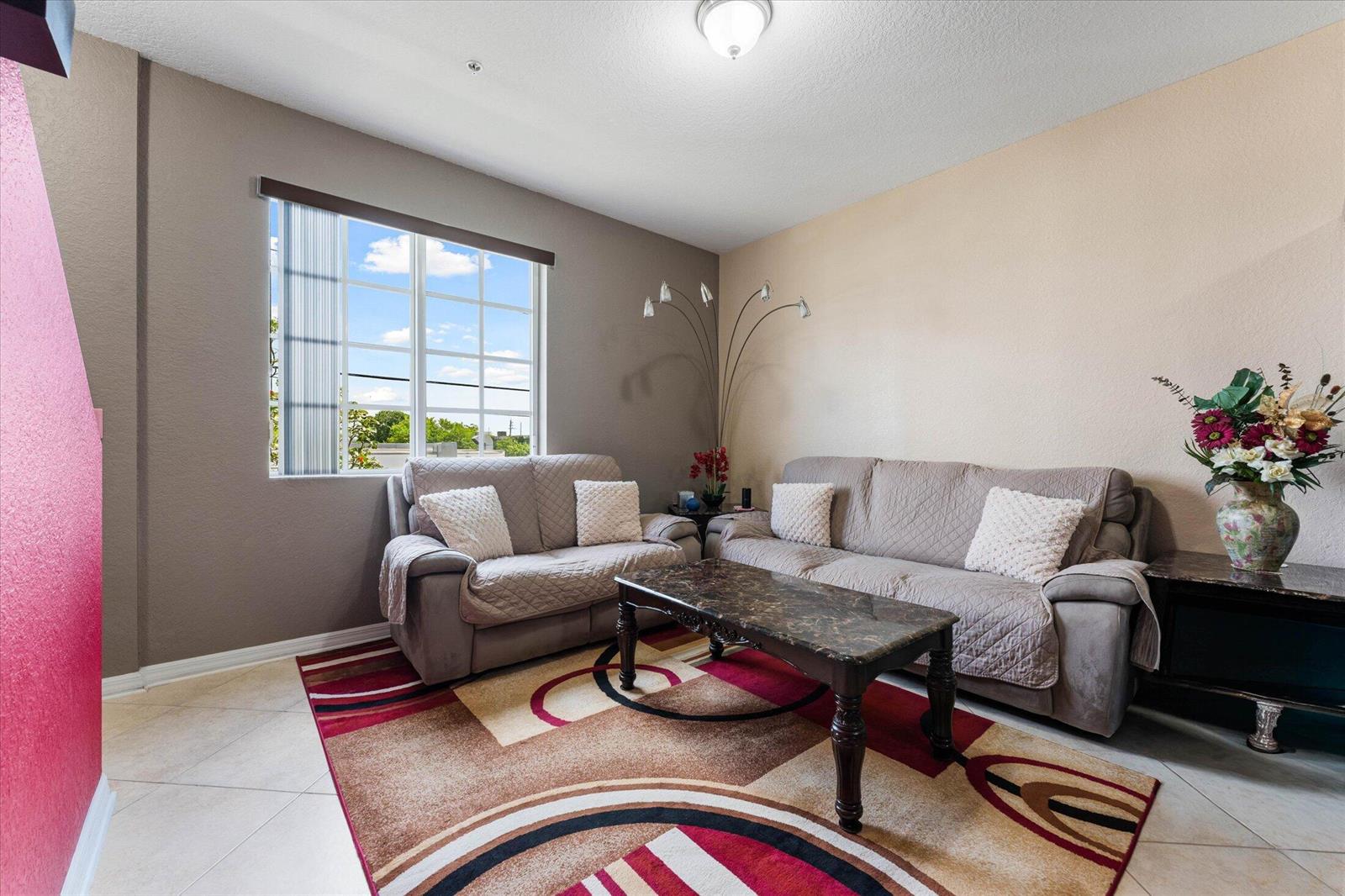 A living room features two gray sofas, a patterned area rug, and a marble coffee table — 131 NW 2nd Avenue # 3, FL 33009, FL