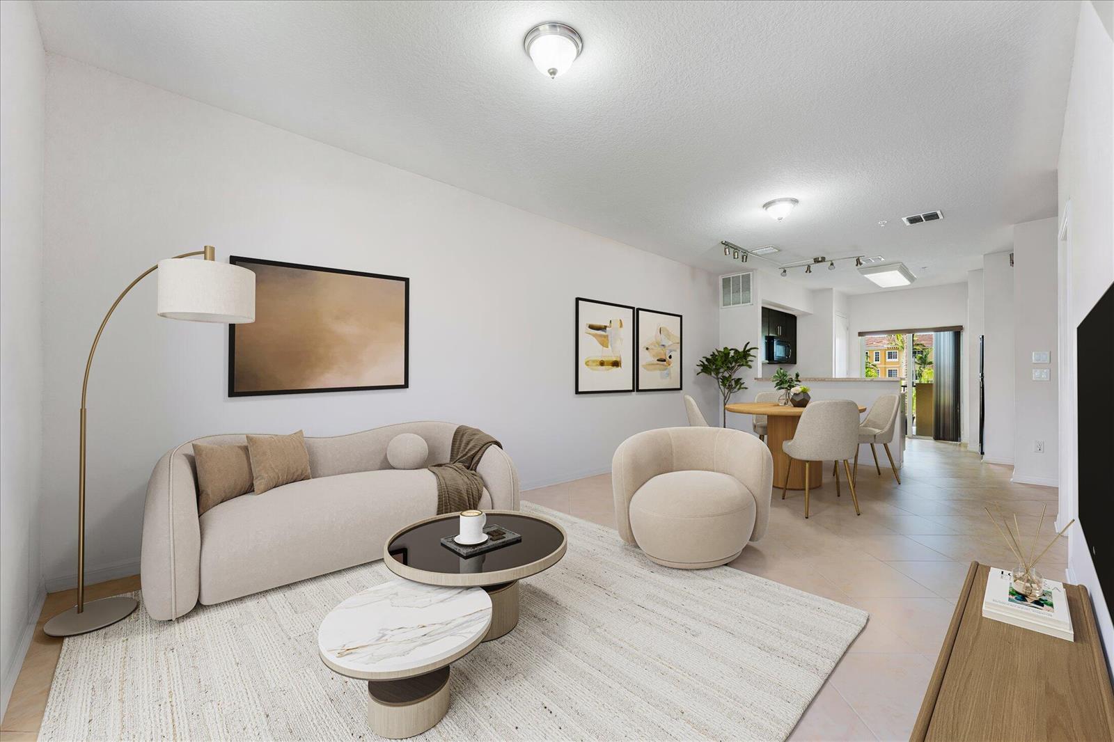 A bright living and dining area features a curved sofa, round tables, and neutral decor — 131 NW 2nd Avenue # 3, FL 33009, FL