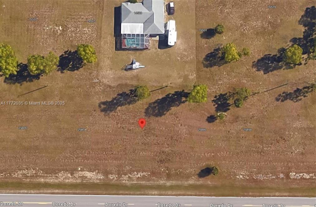 This is an aerial map view showing a residential lot with a house and surrounding land — 25482 Doredo Dr, Punta Gorda FL 33955, PUNTA GORDA, FL