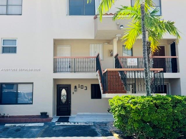The exterior of a two-story residential building features a staircase leading to a second-floor balcony — 5650 W 26th Ct # 206, Hialeah FL 33016, HIALEAH, FL