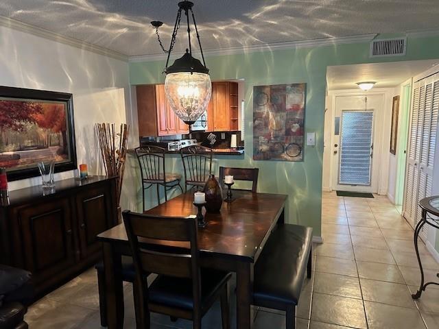 A dining area with a wooden table, chairs, bench, and a hanging pendant light fixture — 9350 Sunrise Lakes Boulevard # 101, Sunrise FL 33322, SUNRISE, FL
