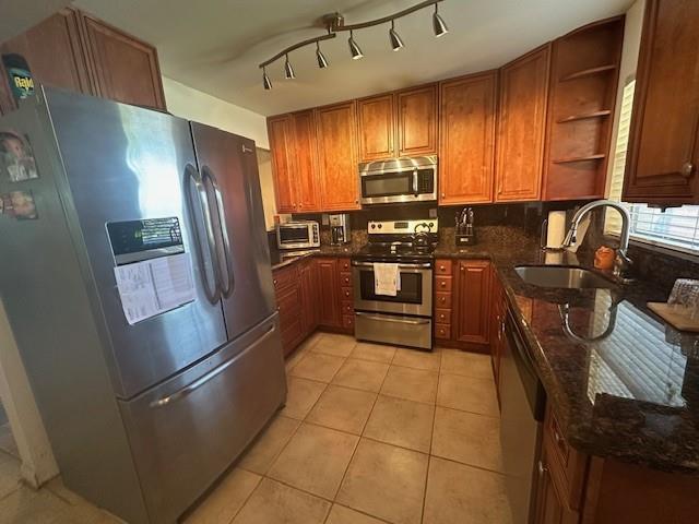 A kitchen features wood cabinets, stainless steel appliances, and dark granite countertops — 9350 Sunrise Lakes Boulevard # 101, Sunrise FL 33322, SUNRISE, FL