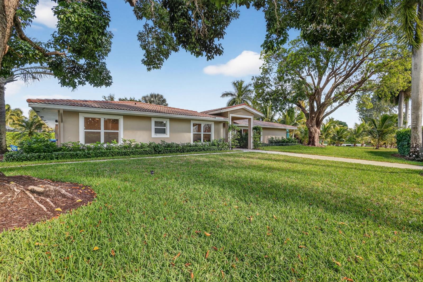 A single-story house with a beige exterior, tiled roof, and a large front lawn — 937 SW 34th Court, Boynton Beach FL 33435, BOYNTON BEACH, FL