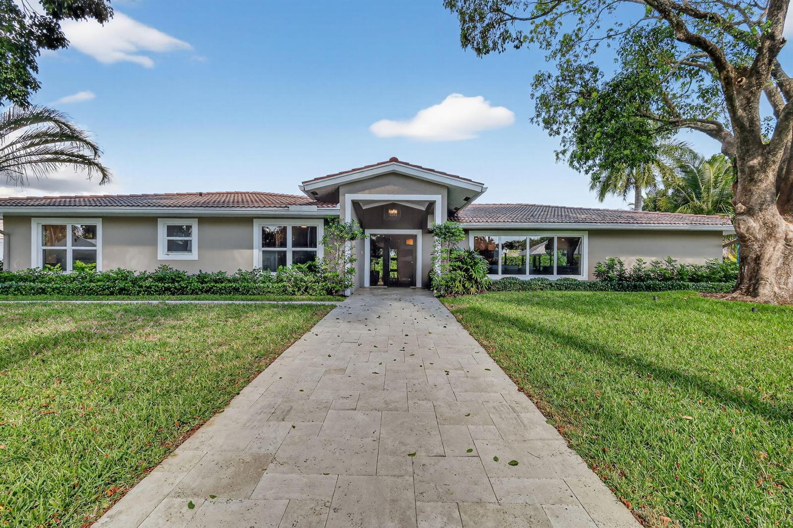A single-story house with a tiled roof, a stone walkway, and a large front tree — 937 SW 34th Court, Boynton Beach FL 33435, BOYNTON BEACH, FL
