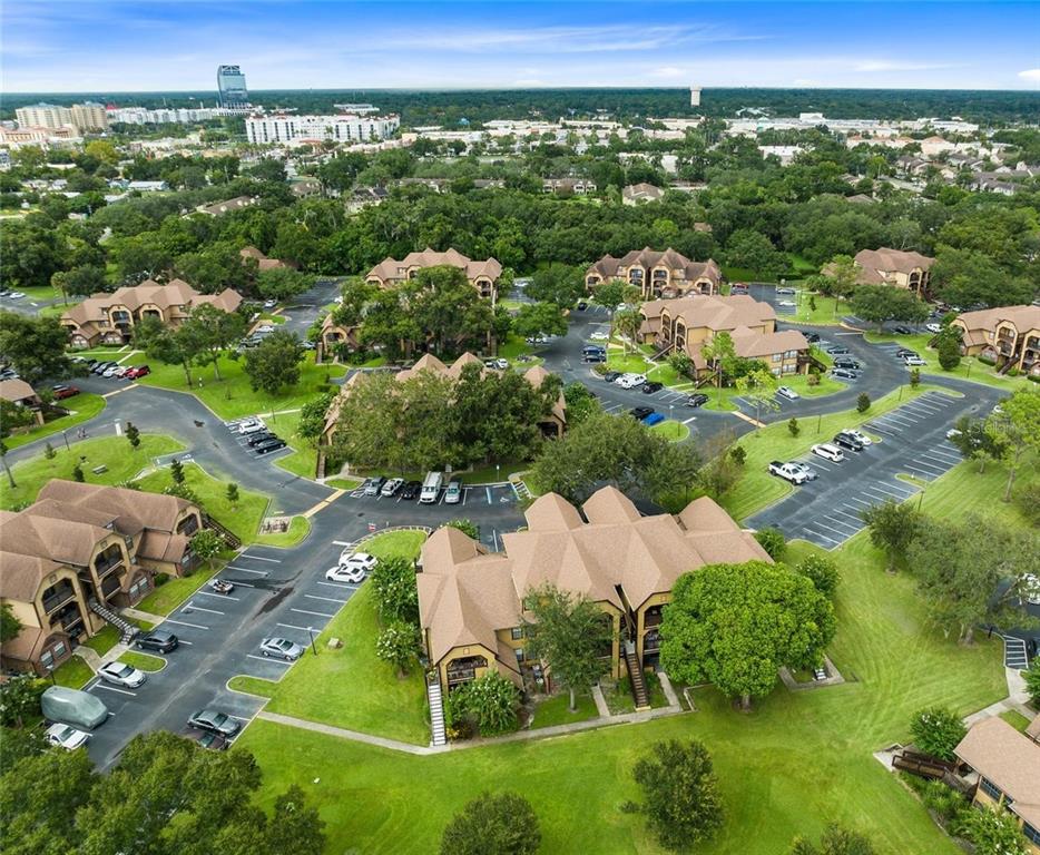 An aerial view shows multiple multi-story apartment buildings surrounded by parking lots and green lawns — 420 FORESTWAY CIRCLE UNIT 307, ALTAMONTE SPRINGS, FL