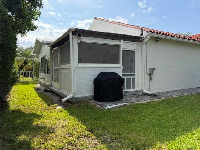 A white screened-in porch with a black grill sits on a paved patio area — 3963 Redondo Court, Boca Raton FL 33487, BOCA RATON, FL