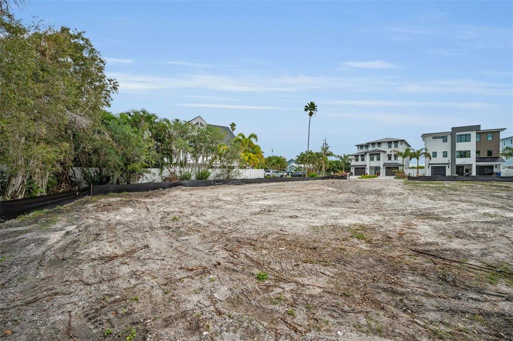 A vacant, cleared residential lot with a black silt fence and surrounding houses — 370 12TH AVENUE, INDIAN ROCKS BEACH, FL