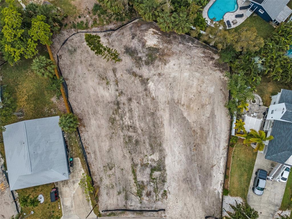 An aerial view shows a cleared, vacant residential lot surrounded by neighboring houses and trees — 370 12TH AVENUE, INDIAN ROCKS BEACH, FL