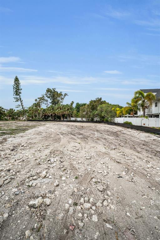 A vacant, cleared lot with sandy soil and sparse vegetation under a clear blue sky — 370 12TH AVENUE, INDIAN ROCKS BEACH, FL