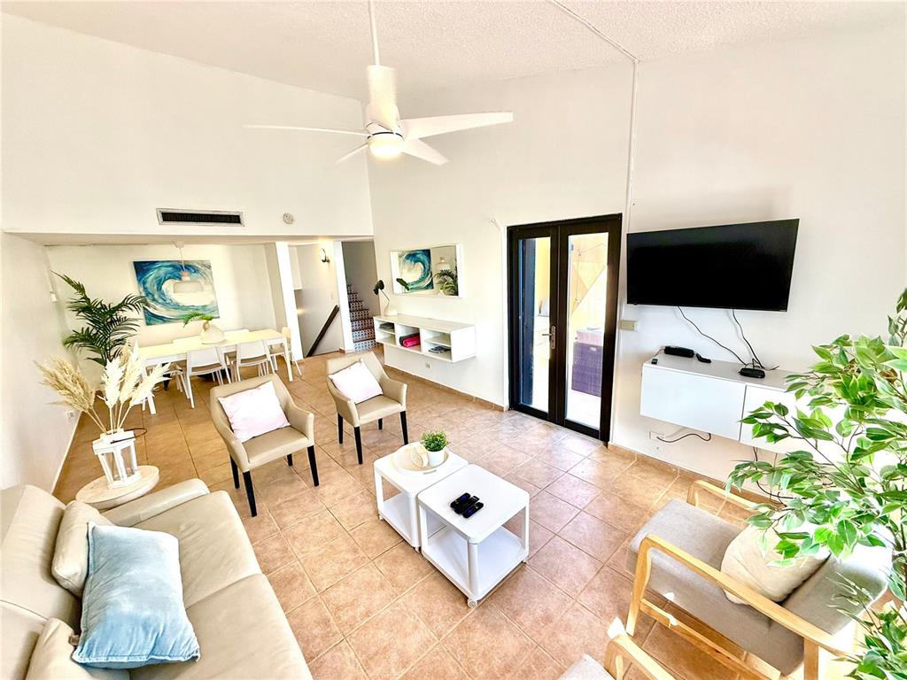 A bright living room with tile floors, a ceiling fan, and a dining area — 999 HARBOURSIDE UNIT 999, HUMACAO, PR