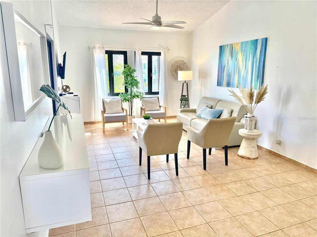 A living room features tile flooring, a beige sofa, two armchairs, and a ceiling fan — 999 HARBOURSIDE UNIT 999, HUMACAO, PR