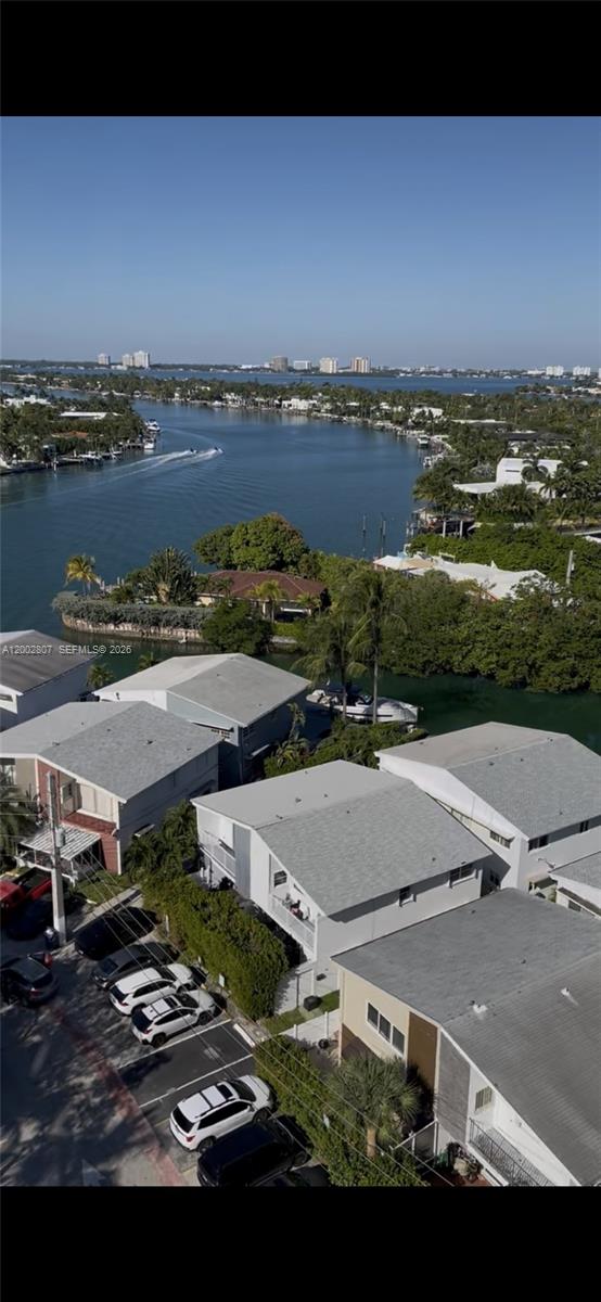 An aerial view shows a residential neighborhood with houses, parked cars, and a waterway — 7441 Wayne Ave # 11A, Miami Beach FL 33141, MIAMI BEACH, FL
