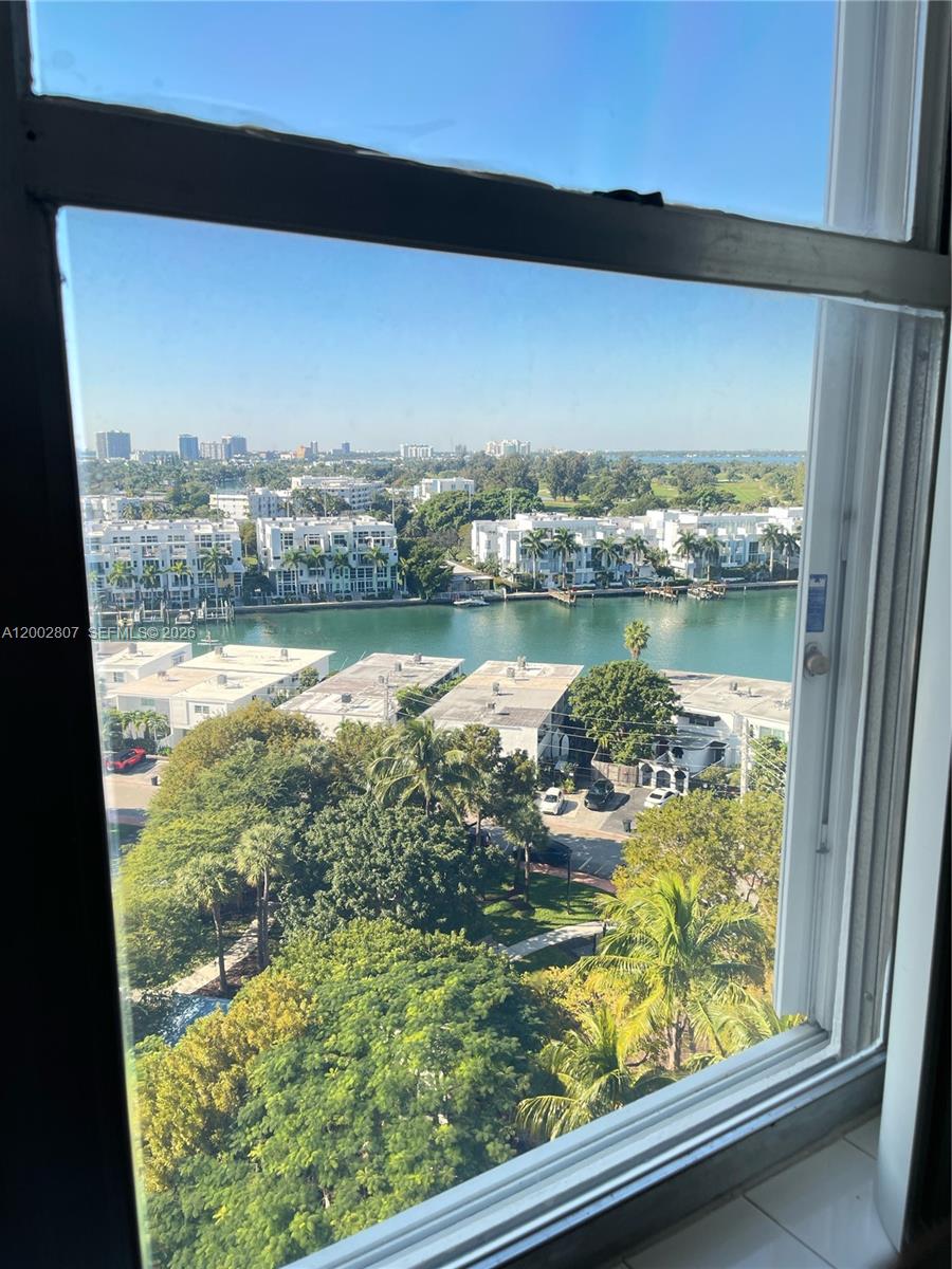 An aerial view of a multi-story apartment building with a swimming pool and parking lot — 7441 Wayne Ave # 11A, Miami Beach FL 33141, MIAMI BEACH, FL