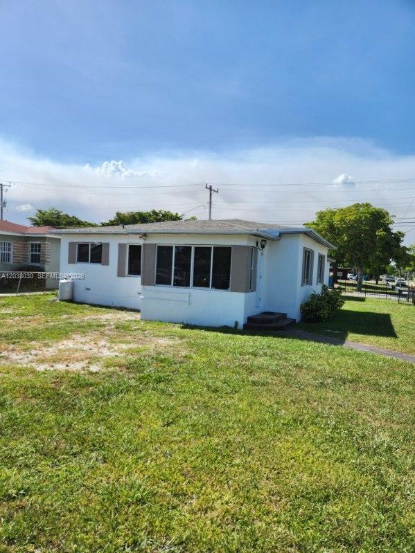 A small, white, single-story house features a front entrance with steps and a tiled walkway — 2501 NW 55th Ter, Miami FL 33142, MIAMI, FL
