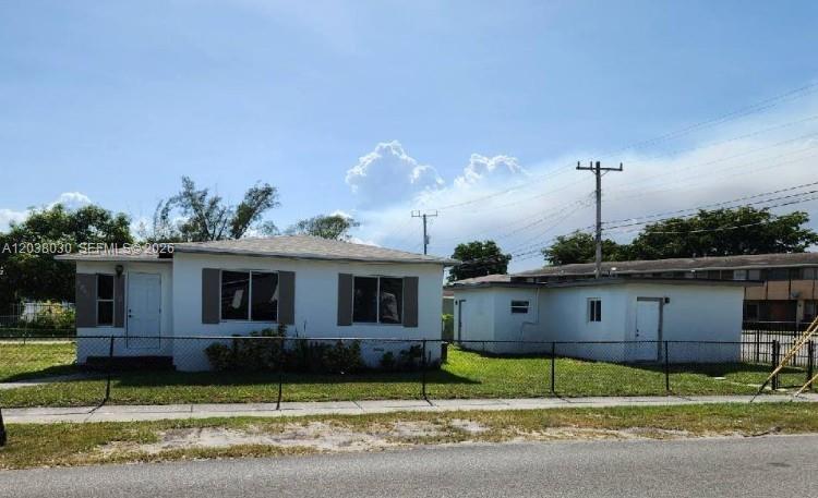 An aerial view shows a corner lot with a white house, a detached garage, and lawns — 2501 NW 55th Ter, Miami FL 33142, MIAMI, FL