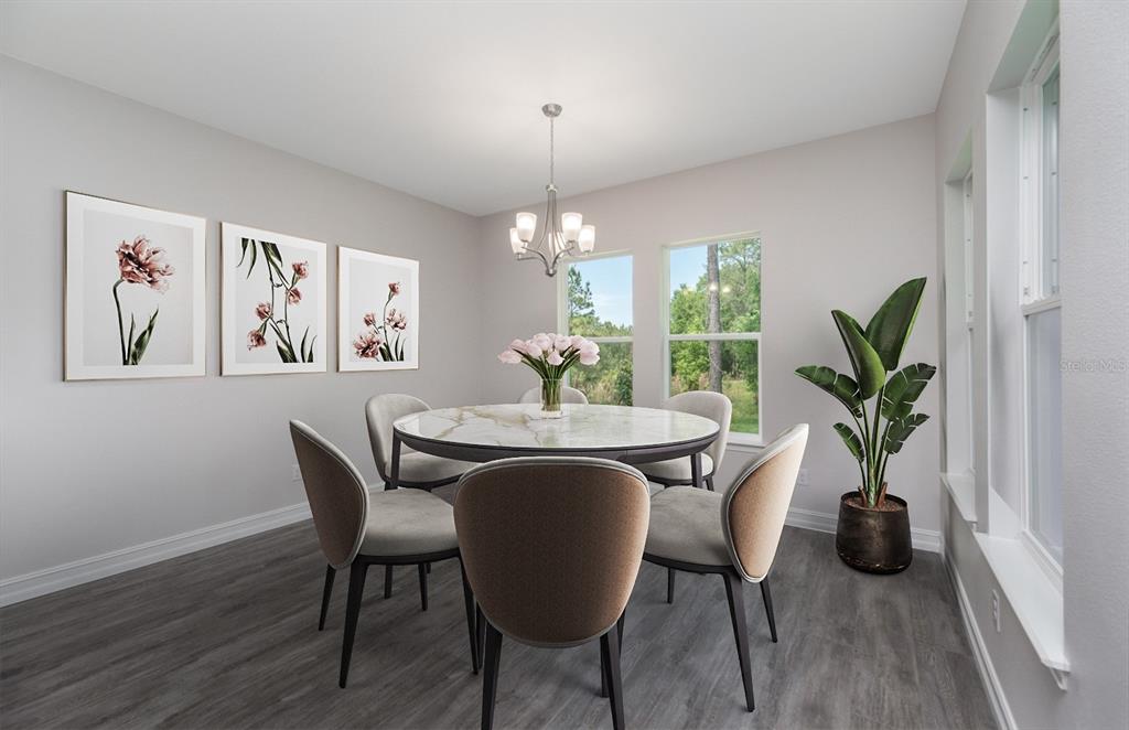 A dining room features a round marble table, six upholstered chairs, and three floral wall prints — 8314 NW 17TH CIRCLE, OCALA, FL