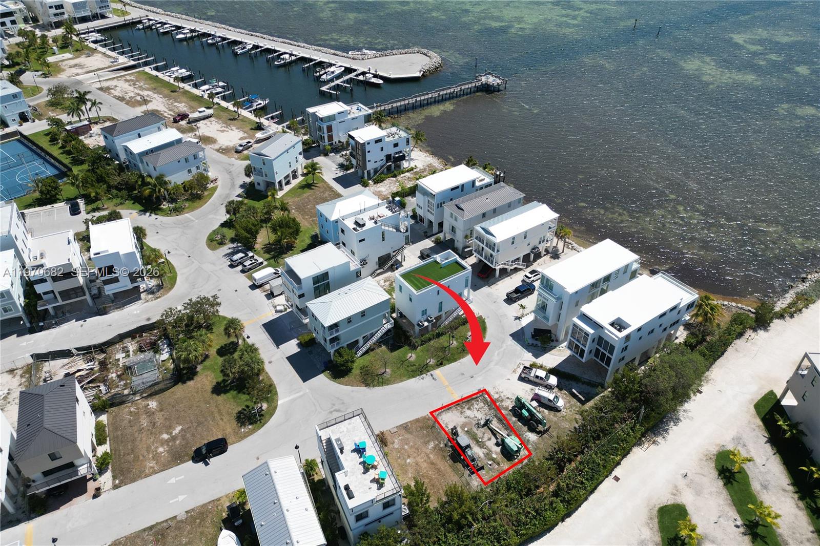 An aerial view shows a vacant lot outlined in red near a waterfront residential neighborhood — 94825 Overseas Hwy, Key Largo FL 33037, KEY LARGO, FL