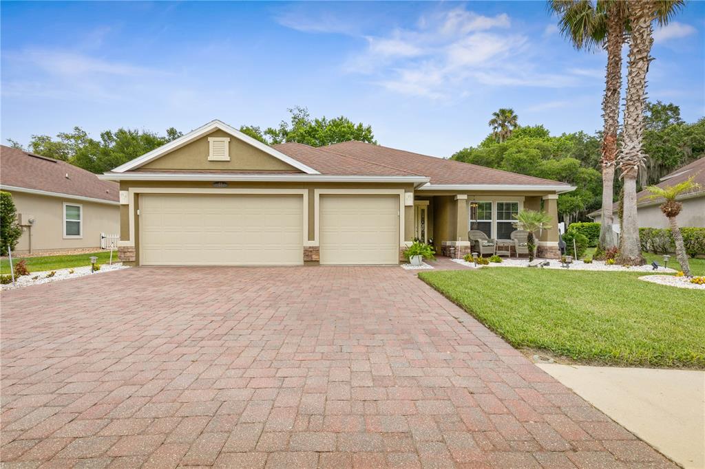 A single-story house with a brick paver driveway, two-car garage, and a covered front porch — 41 AUBERRY DRIVE, PALM COAST, FL