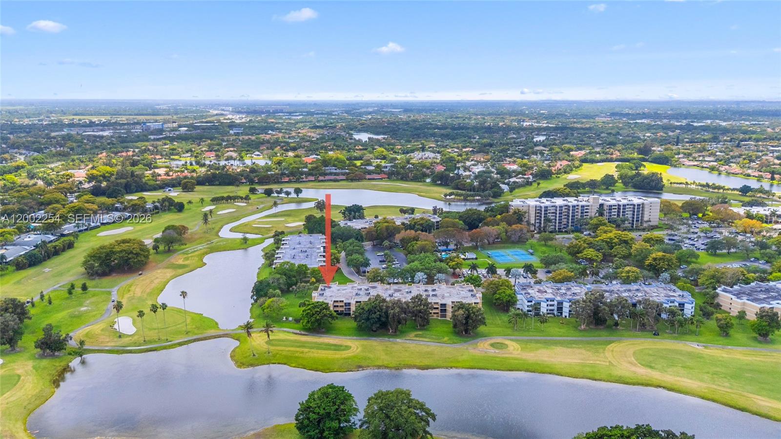 An aerial view shows a multi-story residential building situated on a golf course — 16175 Golf Club Rd # 212, Weston FL 33326, WESTON, FL