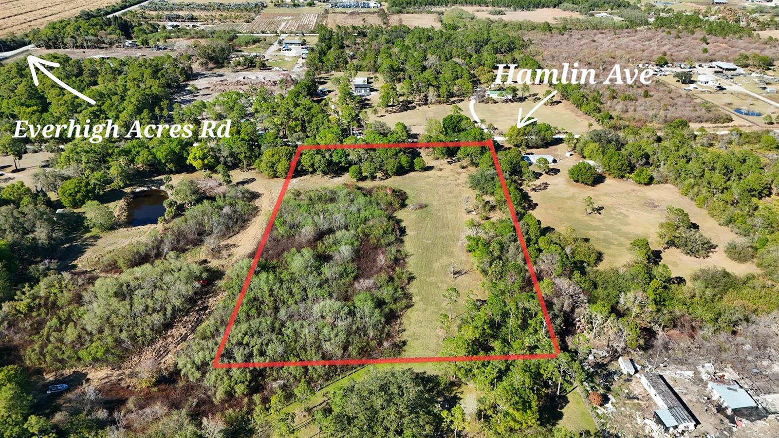 An aerial view shows a rectangular plot of land outlined in red amidst wooded surroundings — 13822 Hamlin Avenue, Clewiston FL 33440, CLEWISTON, FL