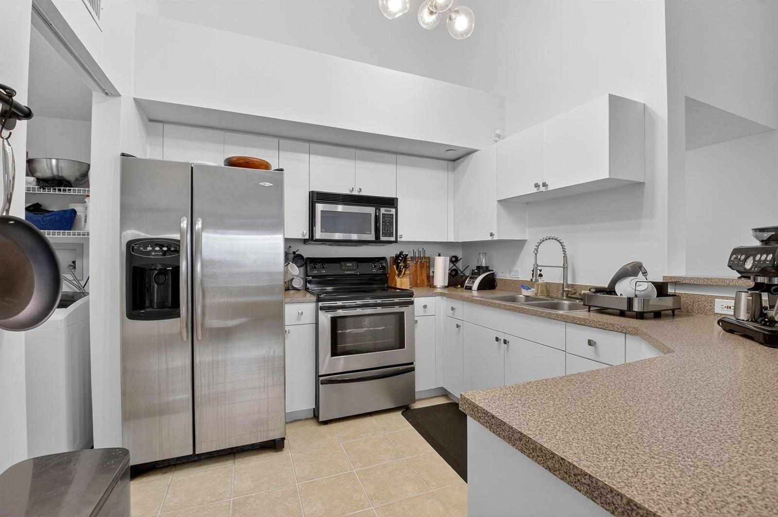 A kitchen with white cabinets, stainless steel appliances, and tan countertops — 224 Villa Circle # 224, Boynton Beach FL 33435, BOYNTON BEACH, FL