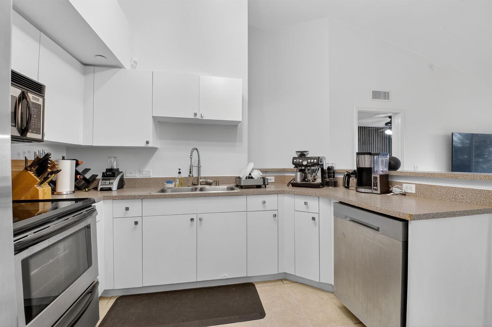 A kitchen with white cabinets, stainless steel appliances, and speckled countertops — 224 Villa Circle # 224, Boynton Beach FL 33435, BOYNTON BEACH, FL