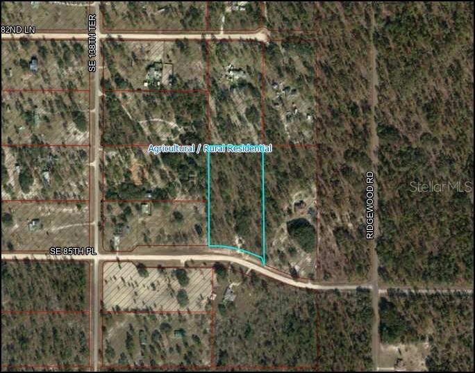 This is an aerial map showing a rectangular plot of land outlined in blue — 13971 SE 85 PLACE, DUNNELLON, FL