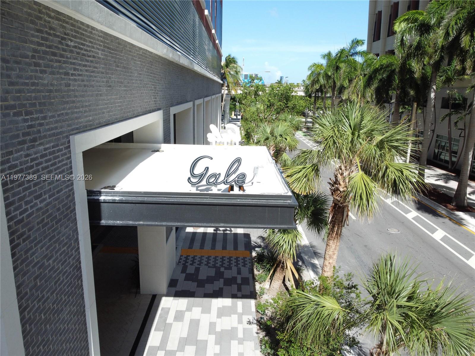 An elevated view of a building entrance with a Gale sign and palm trees — 159 NE 6th St # 3713, Miami FL 33132, MIAMI, FL