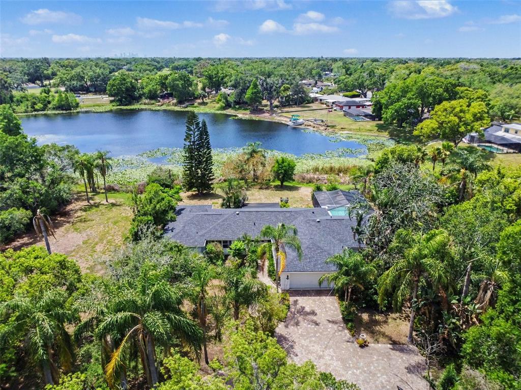 A single-story house with a brick exterior, a two-car garage, and a paved driveway — 1350 ECKLES DRIVE, TAMPA, FL
