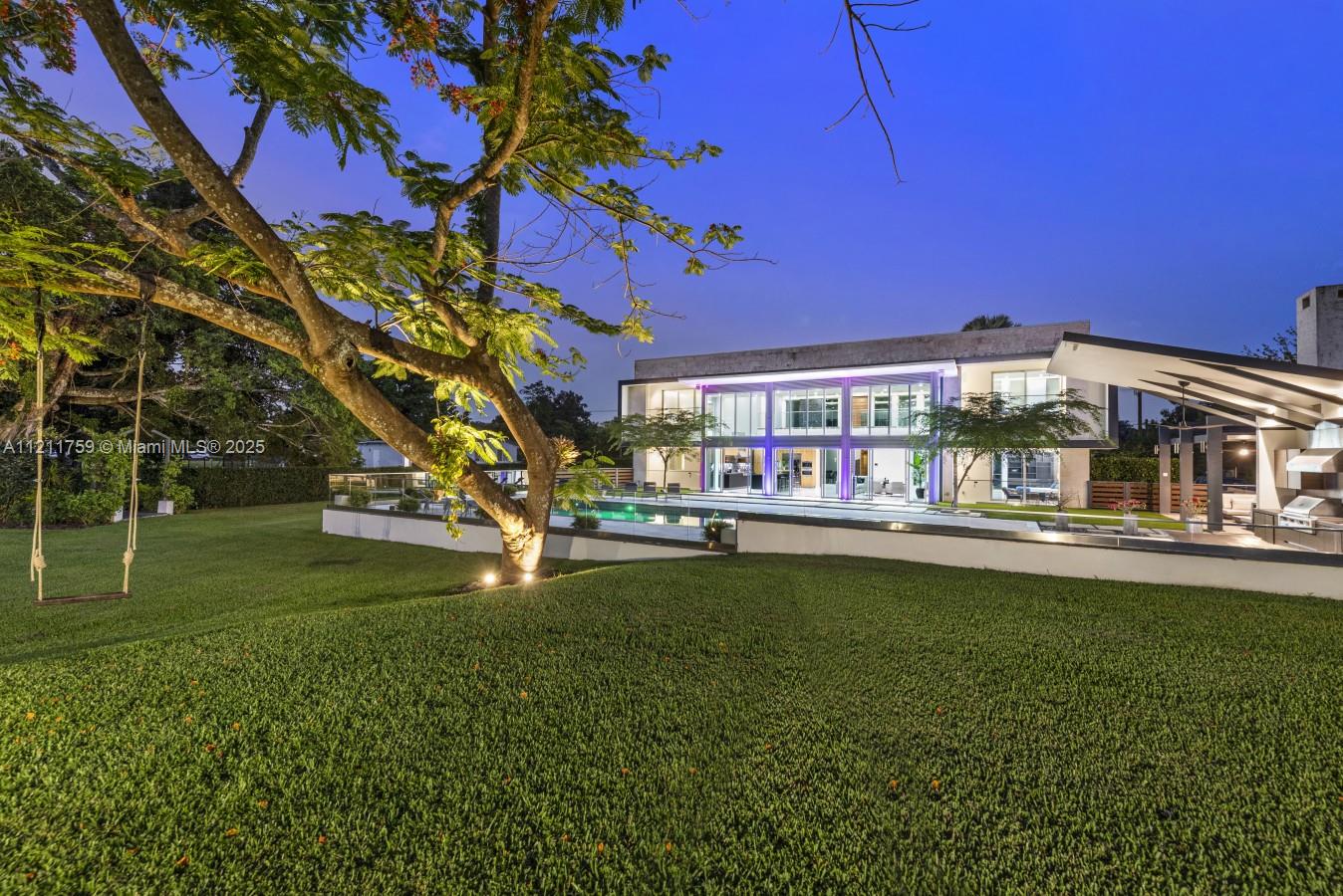 A modern two-story house with a pool and a large lawn at twilight — 14305 Stirling Rd, Southwest Ranches FL 33330, SOUTHWEST RANCHES, FL